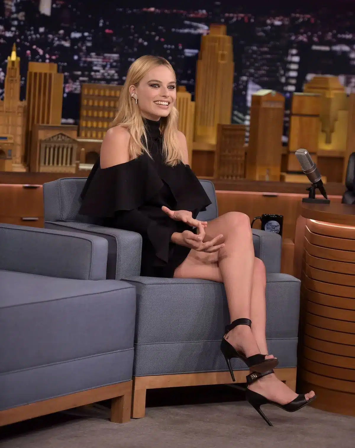 “Margot Robbie laughing naturally with expressive lip movement.”