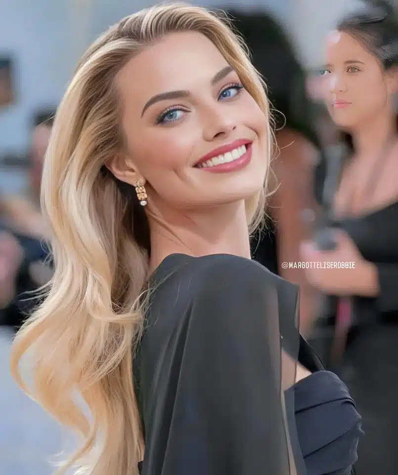 “Margot Robbie smiling confidently with minimal gum display.”