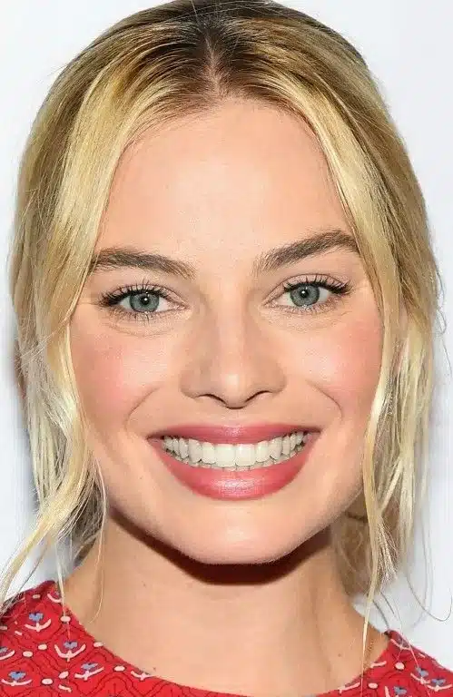 “Margot Robbie’s facial expression captured with gentle smile and bright eyes.”