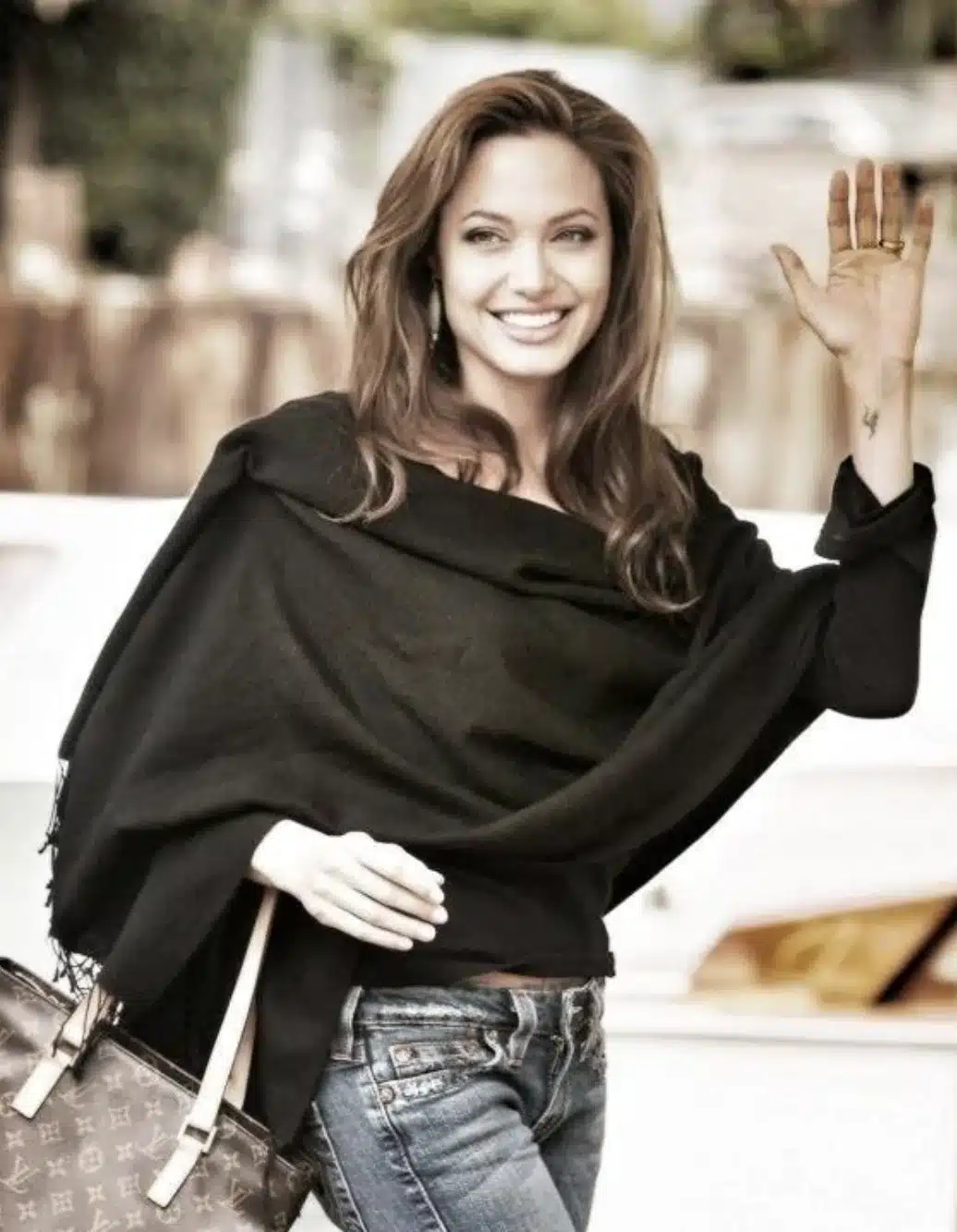 “Angelina Jolie smiling with balanced central-to-lateral tooth proportions.”