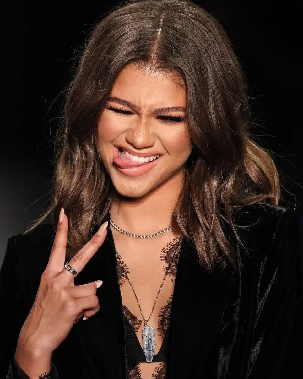 “Zendaya’s iconic youthful smile captured during a candid moment.”