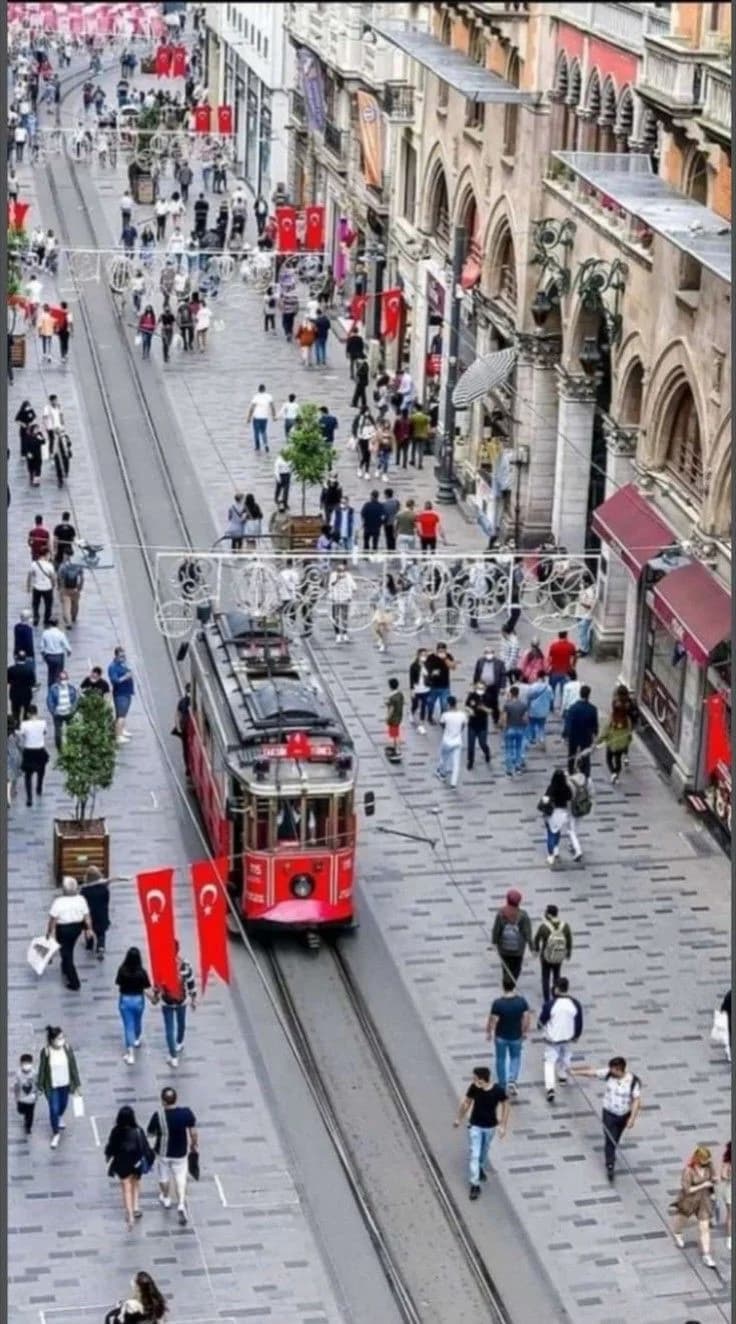 Historic red tram moving through a crowded street in Istanbul