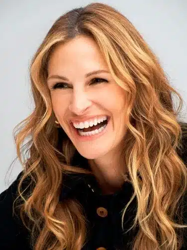 “Julia Roberts smiling with warm-toned teeth and relaxed facial expression.”