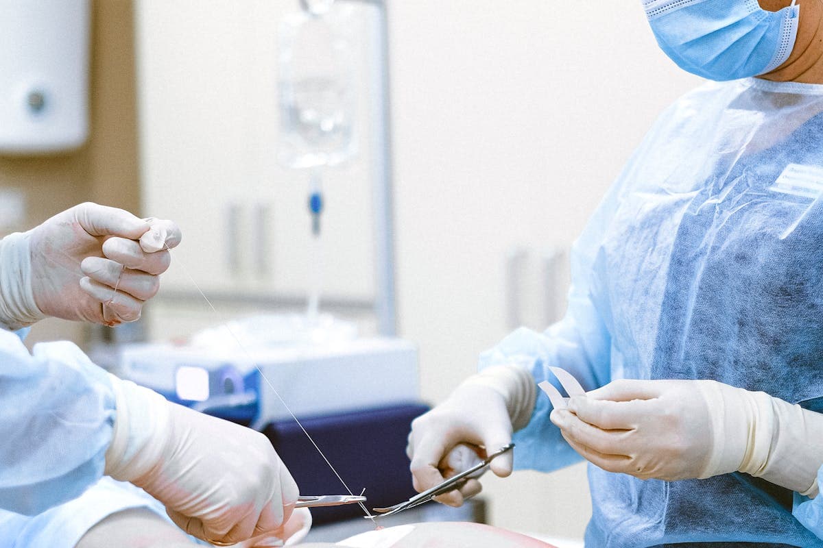 Medical professionals in protective equipment during dental implant surgery