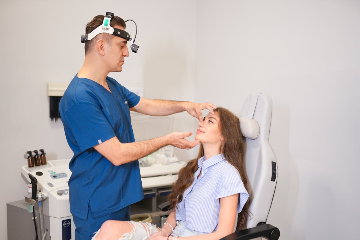 Rhinoplasty consultation with plastic surgeon examining patient nose in Istanbul clinic