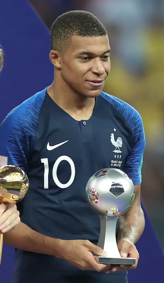 Kylian Mbappé smiling slightly in 2018, at a PSG awards ceremony