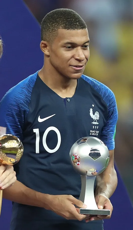 Kylian Mbappé smiling slightly in 2018, at a PSG awards ceremony