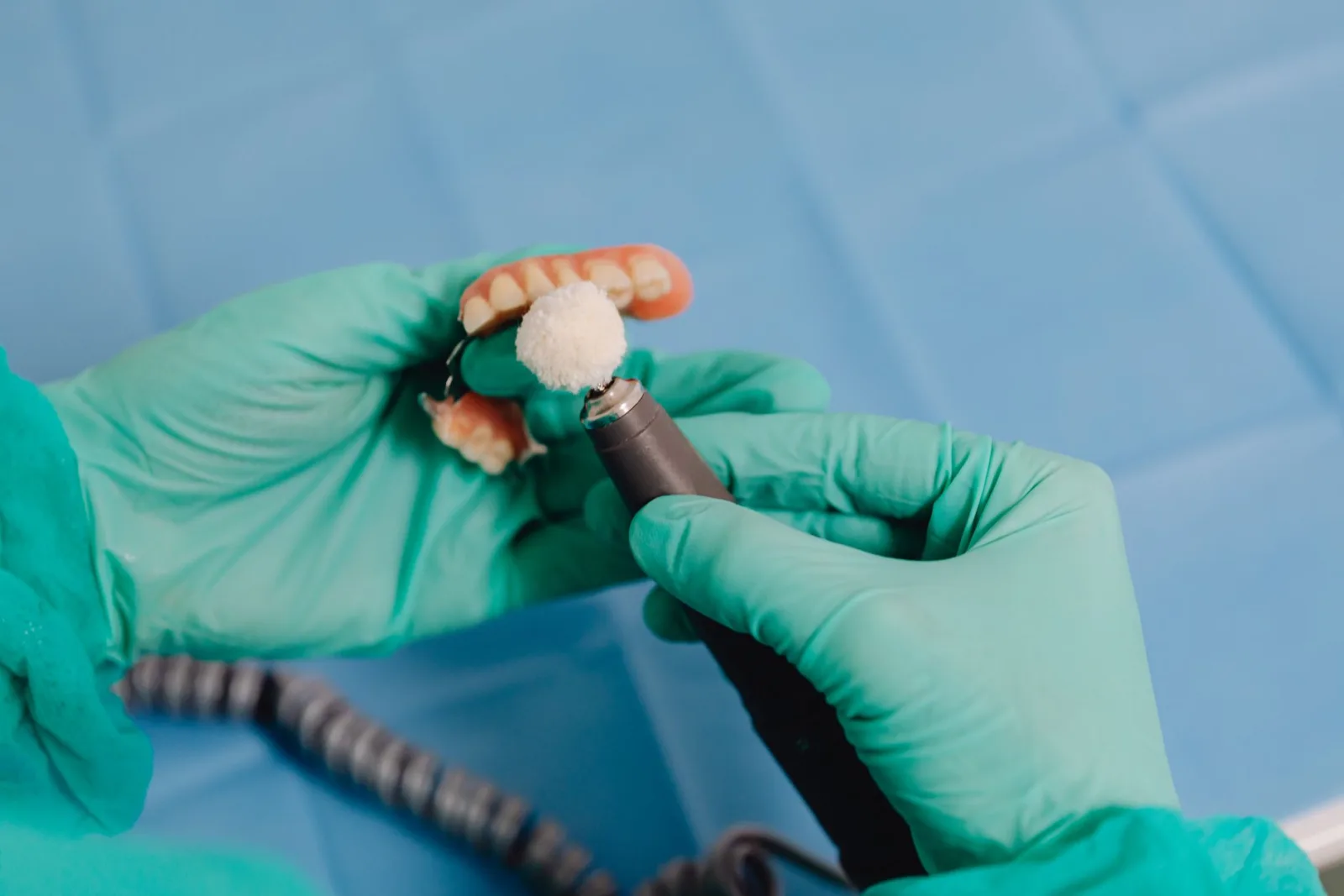 Dental laboratory technician working on a crown or bridge restoration