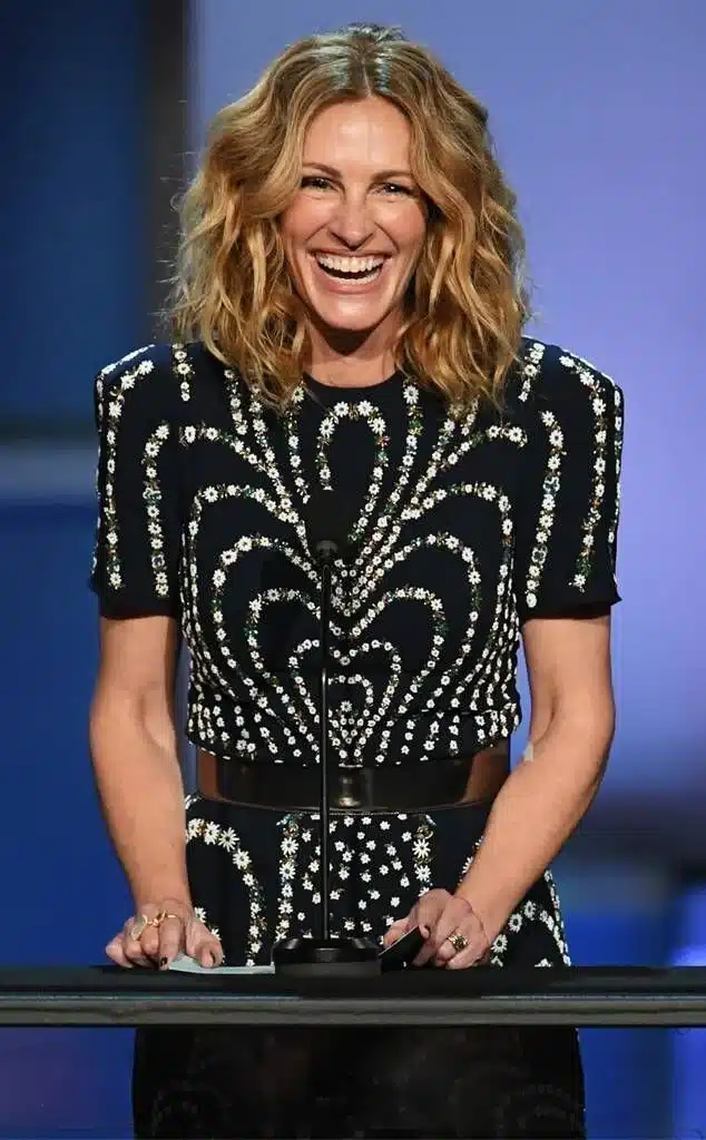 “Profile view of Julia Roberts displaying her signature broad smile.”