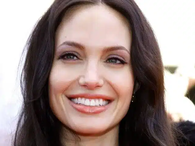 “Angelina Jolie smiling with natural lip-tooth harmony and soft feminine curvature.”