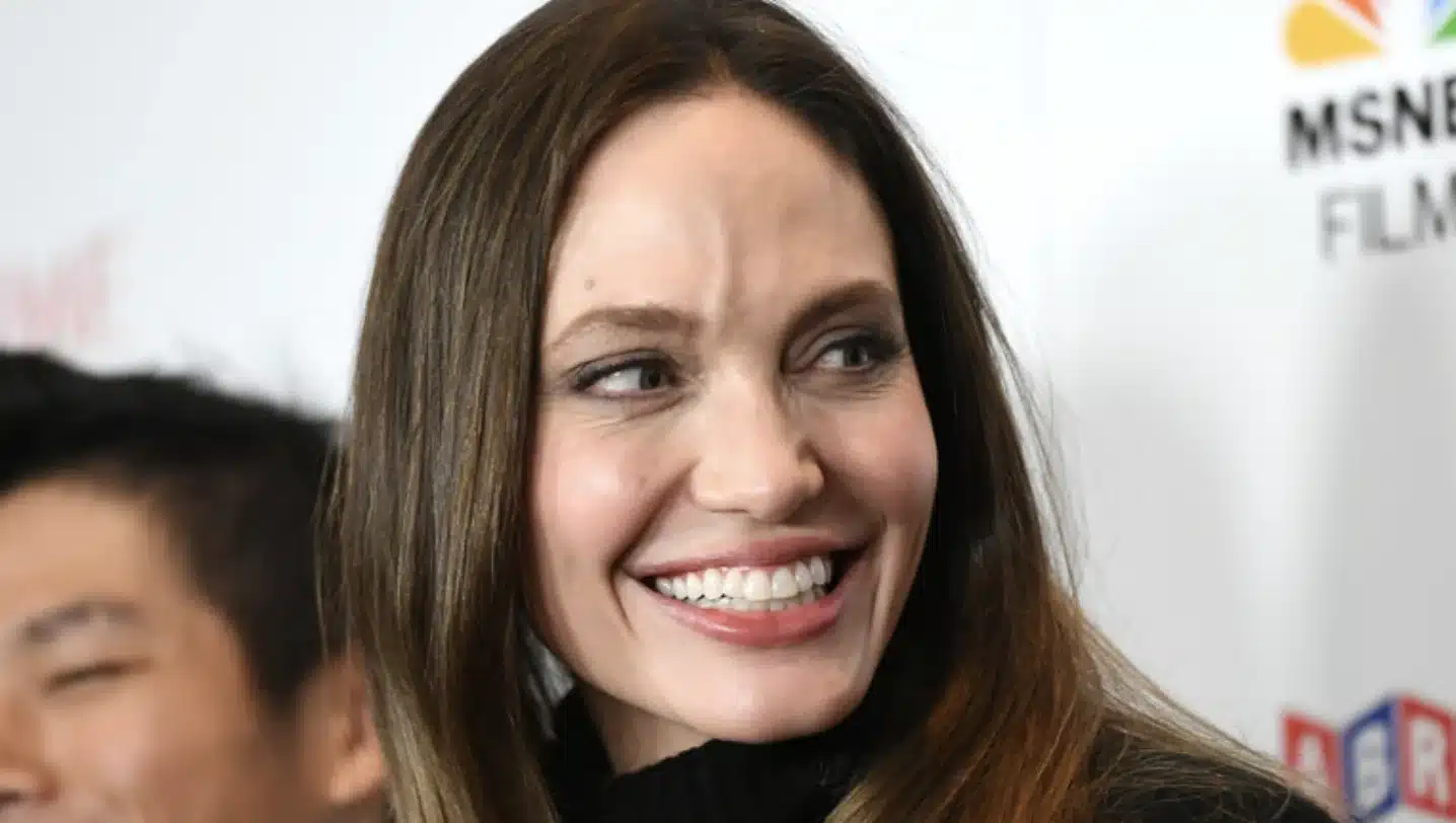 “Artistic portrait of Angelina Jolie highlighting harmony between lips and teeth.”