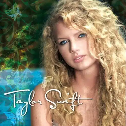 1. “Taylor Swift smiling under warm stage lighting with soft enamel tones.”